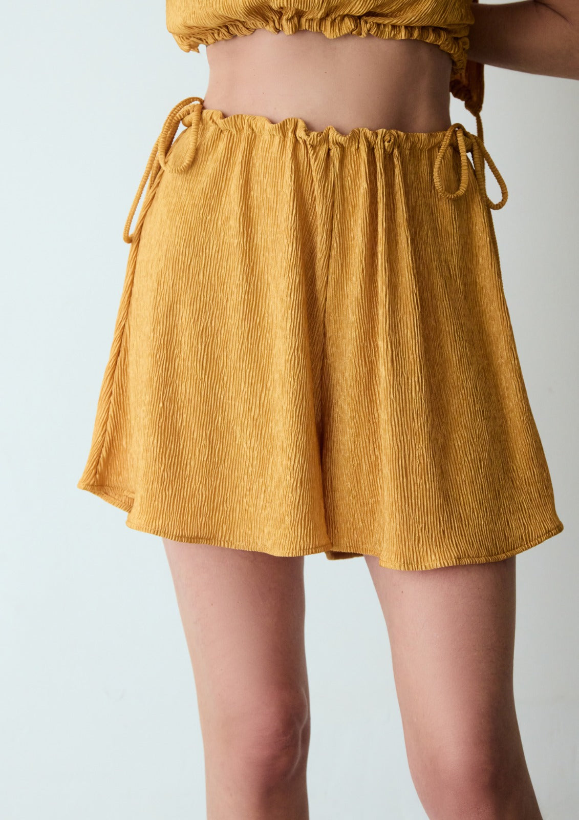 short pleats gold